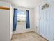 Entryway featuring tile flooring, a window with blinds, and a white front door with a mail slot at 17445 County Road 6, Brighton, CO 80603