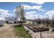 Aerial view of home with fenced yard and garden plots at 17445 County Road 6, Brighton, CO 80603