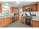 Modern kitchen with stainless steel appliances, wood cabinets, and neutral countertops at 17445 County Road 6, Brighton, CO 80603