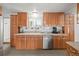 Well-lit kitchen with wood cabinets, stainless steel appliances and tiled backsplash at 17445 County Road 6, Brighton, CO 80603