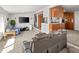 Open-concept living area connecting to the kitchen with comfortable seating at 17445 County Road 6, Brighton, CO 80603