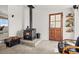 Cozy living area features a wood burning stove and rustic wooden door at 17445 County Road 6, Brighton, CO 80603