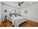 Cozy bedroom featuring hardwood floors, a ceiling fan, and a bright window with neighborhood views at 3351 S Field St # 104, Lakewood, CO 80227
