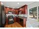 Modern kitchen with stainless steel appliances, cherry cabinets, and natural light at 3351 S Field St # 104, Lakewood, CO 80227
