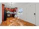 Well-lit kitchen with hardwood floors, modern appliances, and a dining table at 3351 S Field St # 104, Lakewood, CO 80227