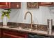 Close-up of a modern kitchen sink with granite countertops at 3351 S Field St # 104, Lakewood, CO 80227