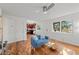 Open-concept living room showcasing hardwood floors, a modern sofa, and natural light from the windows at 3351 S Field St # 104, Lakewood, CO 80227