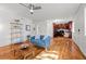Bright living room featuring hardwood floors, a modern ceiling fan, and an open floor plan to the kitchen at 3351 S Field St # 104, Lakewood, CO 80227