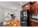 Open floor plan with hardwood floors and modern lighting flowing from kitchen to living area at 3351 S Field St # 104, Lakewood, CO 80227