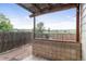 Cozy covered patio with tile accents and an open view of the large backyard at 9669 Jellison Way, Broomfield, CO 80021