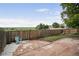 Backyard with a stone patio, grass, landscaping and a wooden fence at 9669 Jellison Way, Broomfield, CO 80021