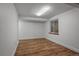 Finished basement with wood-look flooring, window, and ample space for activities at 9669 Jellison Way, Broomfield, CO 80021