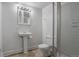 Traditional bathroom with a pedestal sink, tiled floors, toilet, and glass shower doors at 9669 Jellison Way, Broomfield, CO 80021