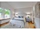 Cozy bedroom with a large window, soft carpet, and ensuite bathroom at 9669 Jellison Way, Broomfield, CO 80021