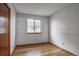Comfortable bedroom featuring hardwood floors, a window with a view, and a closet at 9669 Jellison Way, Broomfield, CO 80021