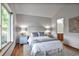 Bright and airy bedroom with a soft color palette, large window, and hardwood flooring at 9669 Jellison Way, Broomfield, CO 80021