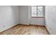 Bright bedroom features hardwood floors, a window with natural light, and white walls at 9669 Jellison Way, Broomfield, CO 80021