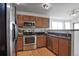 Charming kitchen featuring stainless steel appliances, wood cabinets, and a breakfast bar at 9669 Jellison Way, Broomfield, CO 80021