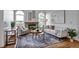 Stylish living room featuring modern decor, hardwood floors, and a cozy fireplace at 9669 Jellison Way, Broomfield, CO 80021