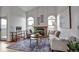 Bright living room with vaulted ceilings, brick fireplace, and large windows for natural light at 9669 Jellison Way, Broomfield, CO 80021
