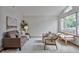 Bright living room with a large window, neutral walls, and modern furnishings at 9669 Jellison Way, Broomfield, CO 80021