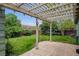 Inviting backyard with a paved patio area, pergola, and well-maintained lawn at 8625 W Dartmouth Pl, Lakewood, CO 80227