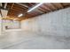 Unfinished basement with concrete walls and floor, plus exposed wood ceiling for potential customization at 8625 W Dartmouth Pl, Lakewood, CO 80227