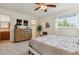 Spacious bedroom offers a large dresser, ceiling fan, cozy bench, window view and well decorated space at 8625 W Dartmouth Pl, Lakewood, CO 80227