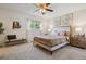 Inviting bedroom with a queen bed, decorative wall art, ceiling fan, and soft, neutral decor at 8625 W Dartmouth Pl, Lakewood, CO 80227