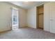 Bright bedroom features a closet, large window, neutral carpet and great natural light at 8625 W Dartmouth Pl, Lakewood, CO 80227