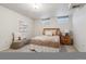 Finished basement bedroom with egress windows, bench, cozy bed and neutral decor at 8625 W Dartmouth Pl, Lakewood, CO 80227