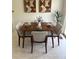 Inviting dining room with mid-century modern table set for four, with bright neutral decor at 8625 W Dartmouth Pl, Lakewood, CO 80227