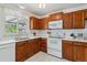 Updated kitchen showcasing quartz countertops, wood cabinets, and modern appliances at 8625 W Dartmouth Pl, Lakewood, CO 80227