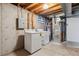Basement laundry room features white washer/dryer units and utility connections ready for use at 8625 W Dartmouth Pl, Lakewood, CO 80227