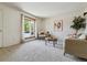 Inviting living room featuring a large bay window, plush carpet, and modern décor at 8625 W Dartmouth Pl, Lakewood, CO 80227