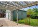 Charming patio featuring wood pergola with stamped concrete and lush landscaping at 8625 W Dartmouth Pl, Lakewood, CO 80227