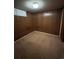 Finished basement bedroom with wood paneled walls at 440 Empire St, Aurora, CO 80010