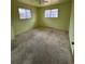 Bedroom with light green walls and stained carpet at 440 Empire St, Aurora, CO 80010