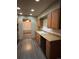 View of kitchen with orange cabinets, black appliances, and laminate flooring at 440 Empire St, Aurora, CO 80010