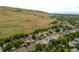 Aerial view of a neighborhood featuring a house with a fenced backyard, near hills and mountains at 14261 W Evans Cir, Lakewood, CO 80228
