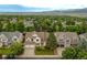 Expansive aerial view of a residential neighborhood with well-maintained homes and abundant green trees at 14261 W Evans Cir, Lakewood, CO 80228