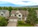 Aerial view of a charming two-story home with lush landscaping and mountain views at 14261 W Evans Cir, Lakewood, CO 80228