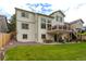 Large backyard featuring a patio, upper deck, and lush lawn perfect for outdoor activities and entertaining at 14261 W Evans Cir, Lakewood, CO 80228
