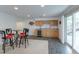 Basement rec room featuring a wet bar and walkout access to the backyard area at 14261 W Evans Cir, Lakewood, CO 80228