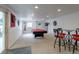 Finished basement featuring a pool table, bar, and ample space for entertaining at 14261 W Evans Cir, Lakewood, CO 80228
