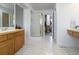 Bright bathroom with walk-in shower, double vanity, and light neutral tones at 14261 W Evans Cir, Lakewood, CO 80228