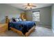 Comfortable bedroom with large window, ceiling fan, and a picturesque view at 14261 W Evans Cir, Lakewood, CO 80228