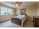 Comfortable bedroom with a large window and ceiling fan providing ample natural light at 14261 W Evans Cir, Lakewood, CO 80228