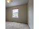 Empty bedroom with a window, neutral paint, and plush carpeting, ready for personalization at 14261 W Evans Cir, Lakewood, CO 80228