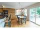 Bright kitchen with a dining area, wooden cabinets, and a sliding glass door to the deck at 14261 W Evans Cir, Lakewood, CO 80228